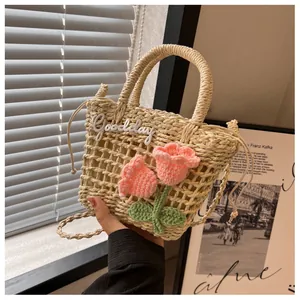 Detail of straw woven tote featuring pink crochet tulips and Goodday embroidery texture