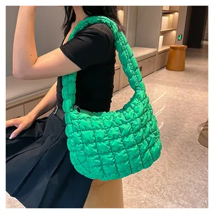 Detailed view of the bright green quilted puffy bag with bubble texture and soft strap