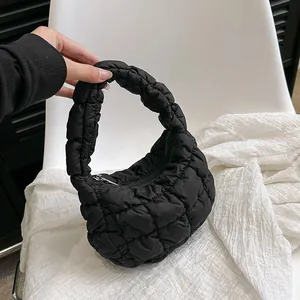 Chic black quilted cloud bag with padded nylon texture and integrated handle for women