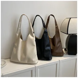 Detailed comparison of minimalist large tote bags in cream, black, and dark brown faux leather