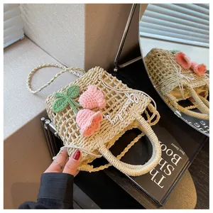 Detailed shot of handmade straw bag featuring floral crochet and Goodday embroidery