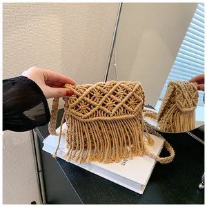 Close-up of bohemian woven shoulder bag featuring intricate crochet patterns and long tassels