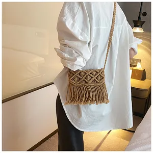 Detailed macro of a woven macrame crossbody bag with decorative fringe and tassels