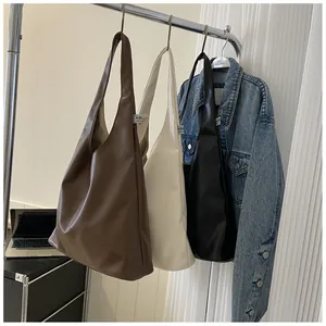 Detailed display of large PU leather tote bags in brown, beige, and black colors