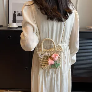 Handwoven straw tote bag with pink crochet flowers and Good day embroidery for beach holiday