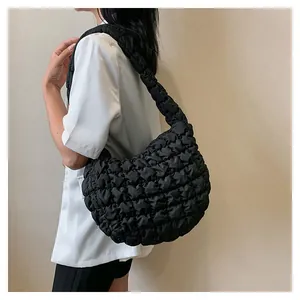 Detail of black quilted puffer shoulder bag showing bubble texture and large capacity