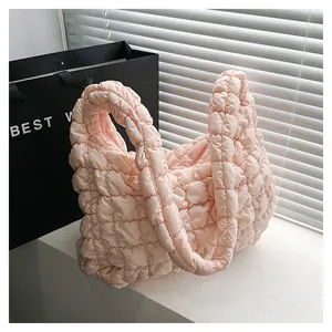 Pink quilted cloud bag with puffy texture and shoulder strap in a stylish design