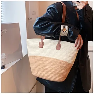 Close-up of color-block woven tote bag with leather straps on a black blazer model