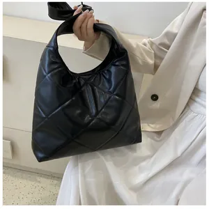 Close-up of a black quilted tote bag with diamond pattern and large capacity