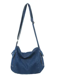 Minimalist dark blue denim tote bag with side flap pockets and adjustable strap