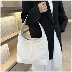 Detail of quilted diamond pattern on cream white PU leather oversized tote bag