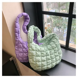 Detailed texture of quilted puffer tote bags in lavender and mint green colors