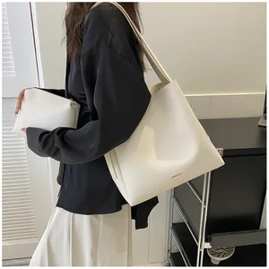 Detail showing white minimalist PU leather tote bag set with matching zipper pouch