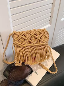 Handmade woven straw crossbody bag with long tassels and bohemian knit pattern