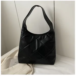 Detail of black quilted hobo shoulder bag with large diamond stitching and soft finish