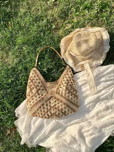 Hollow knit straw tote bag with color blocking and brown straps for summer beach style