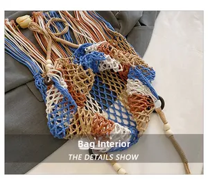 Detailed view of handmade hollow woven beach bag with wooden beads and long tassels
