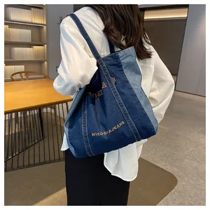 Detailed back view of a patchwork denim tote bag with vibrant embroidery on shoulder