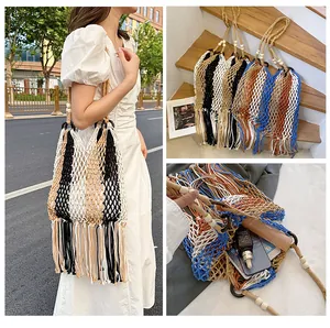Close-up of bohemian woven bag with fringe tassels and wooden bead strap details