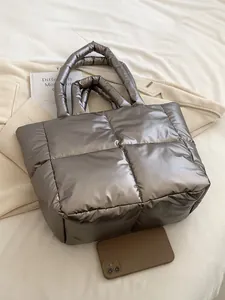 Quilted metallic bronze puffer tote bag with large capacity shown on cozy home background