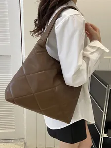 Brown quilted faux leather large tote bag shown from a side view for daily commuting