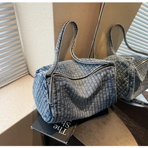 Detailed view of striped washed denim shoulder bag with retro texture and metal zipper