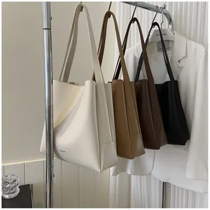 Detail showing four minimalist faux leather tote bags in white, khaki, brown, and black colors