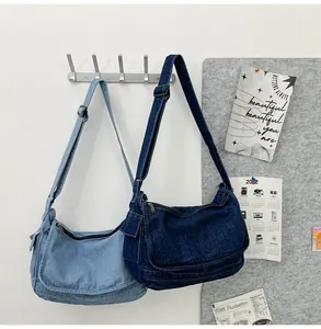 Detail view of large denim tote bags in light and dark blue with adjustable straps
