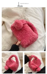 Detail view of pink plush faux fur handbag with soft pom-pom charm and metal zipper