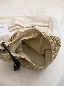 Large straw tote bag with fabric lining and dark brown tassel for summer beach vacations