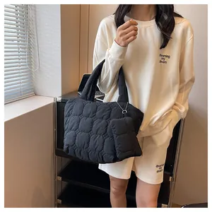 Quilted puffer tote bag in black with matching mini pouch and padded shoulder handles