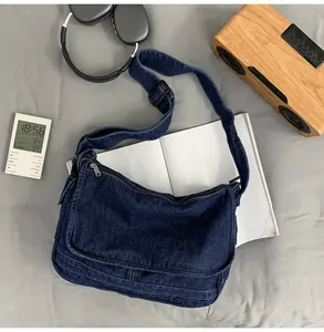 Detailed top view of a large denim tote bag with wide strap and retro wash finish