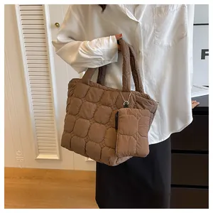 Detail of brown quilted puffer tote bag with a matching small zipper coin purse