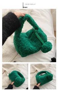 Detail of green faux shearling plush bag with chain strap and fuzzy ball charm accessory