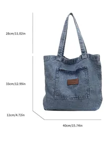 Large blue denim tote bag with front pocket and size markings on white background