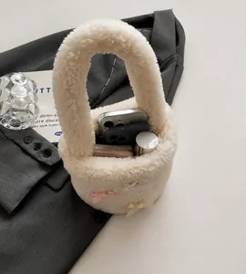 Top view of white fuzzy bucket bag interior showing capacity for phone and wallet
