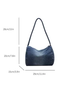 Blue washed denim shoulder bag with striped texture and dimensions for casual daily wear