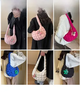 Various colored quilted cloud shoulder bags styled with flower charms on models