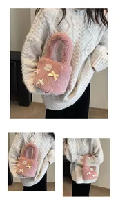 Detailed view of pink plush bucket bag featuring decorative ribbon bows and lace patch