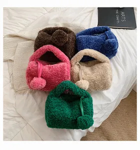 Flat lay of colorful plush handbags in brown, blue, pink, beige, and green with fur charms