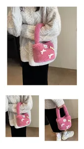Pink plush faux fur bucket bag with white bows and lace-trimmed logo detail