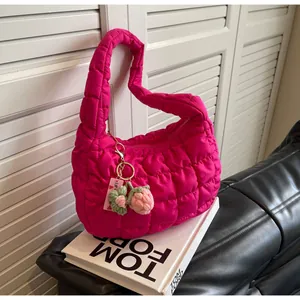 Detail of rose red quilted cloud bag with a handmade strawberry crochet pendant