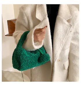 Detail of bright green sherpa mini bag with soft plush texture and golden metal chain strap