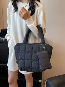 Quilted puffer tote bag in black with matching small pouch for daily commute