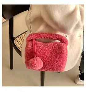 Detail of pink plush crossbody bag with lamb wool texture and silver chain strap