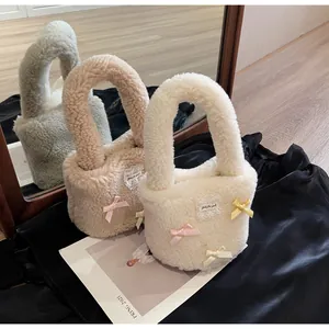 Detail of plush lamb wool bucket bags featuring colorful silk bows and lace patches