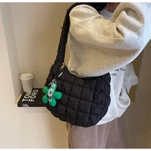 Quilted cloud shoulder bag in black fabric with green flower charm for daily style