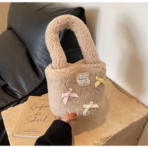 Close-up of beige faux fur bucket bag with colorful bows and lace embroidery detail
