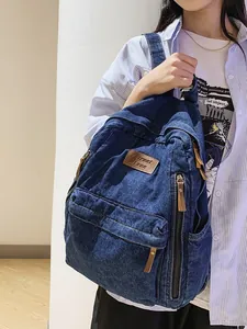 Vintage dark blue denim backpack with leather patch and multiple zipper pockets