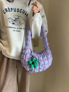 Purple quilted cloud hobo bag for women with green flower charm and soft puffer texture